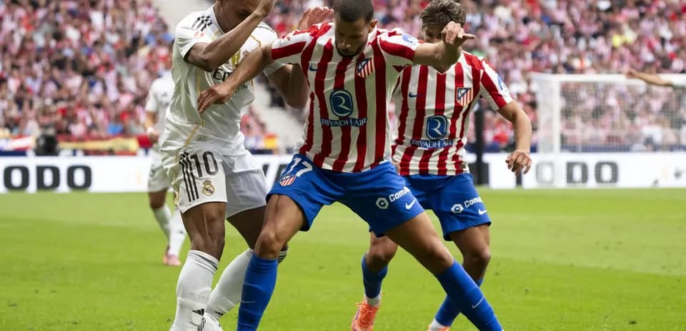 Real Madrid and Atletico Madrid players battling for the ball