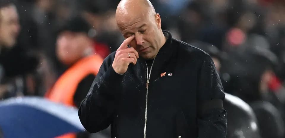 Coach wiping brow during rainy match atmosphere