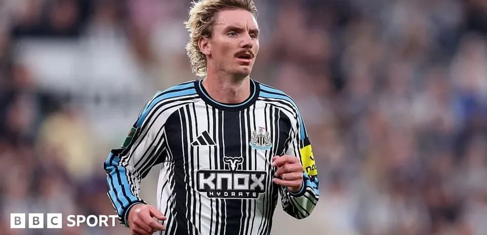 Player running in Newcastle United home kit during match