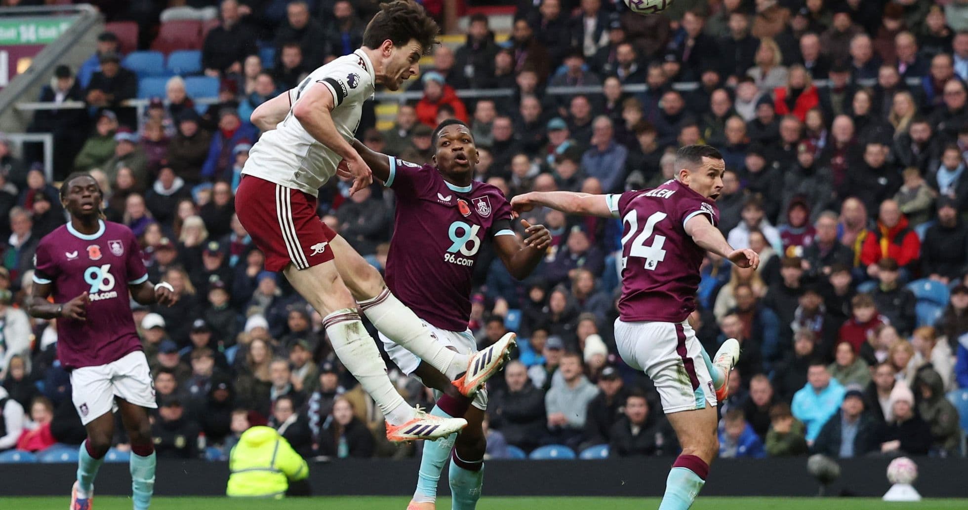 Arsenal player jumping for the ball against Burnley