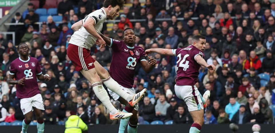 Arsenal player jumping for the ball against Burnley