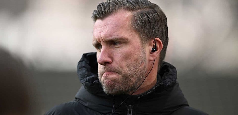 Coach wearing headphones during training session