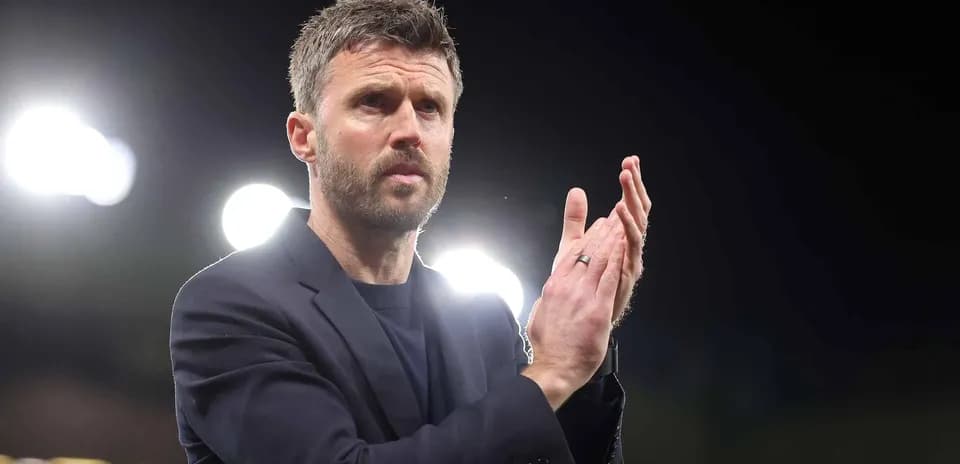 Coach applauding during a match at night