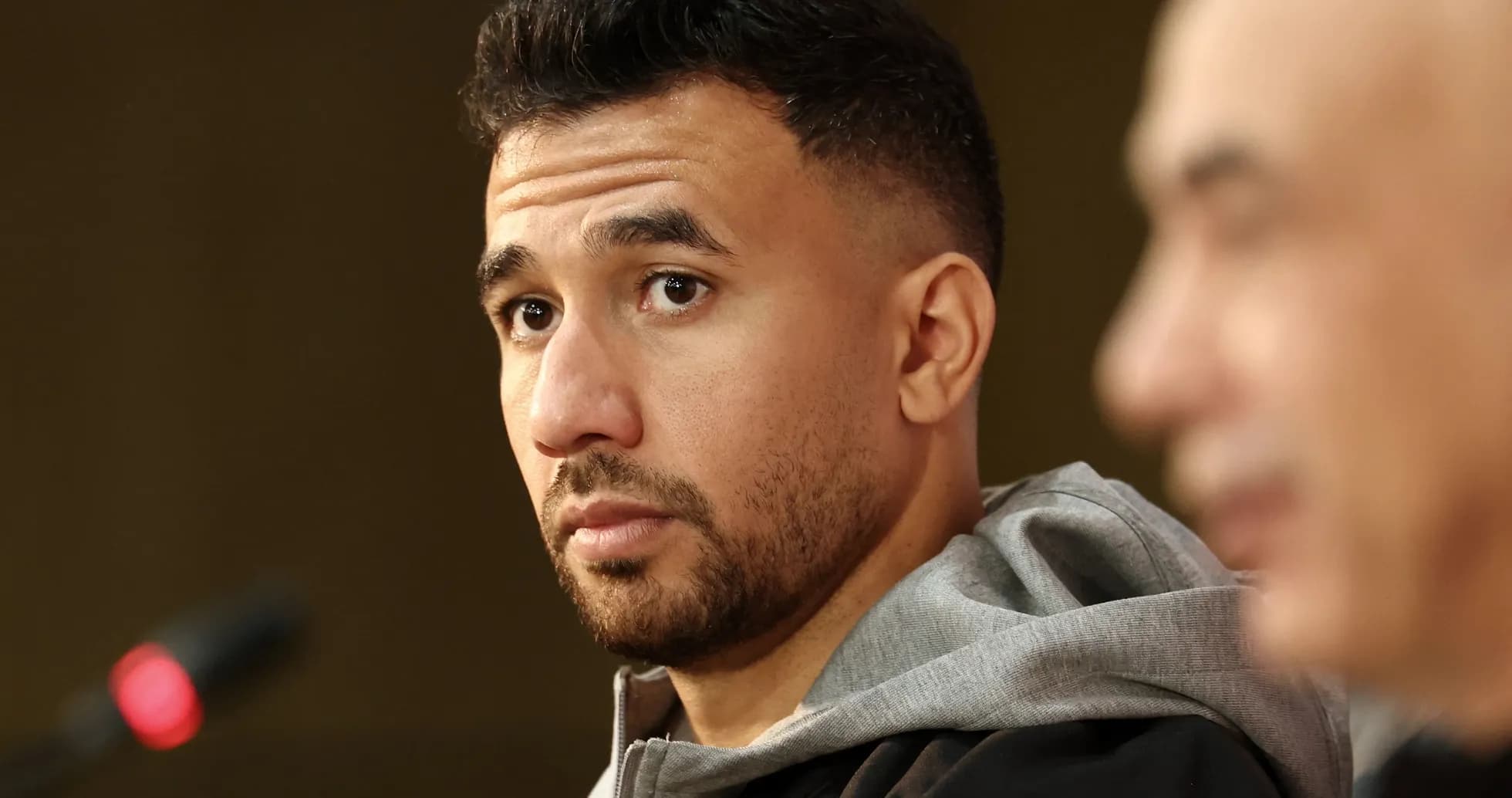 Player attending press conference with microphone in foreground