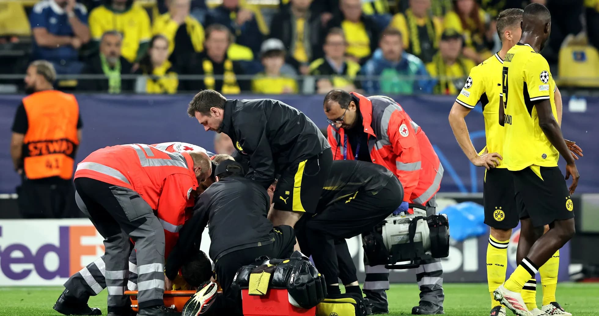 Medical staff attending to an injured player on field