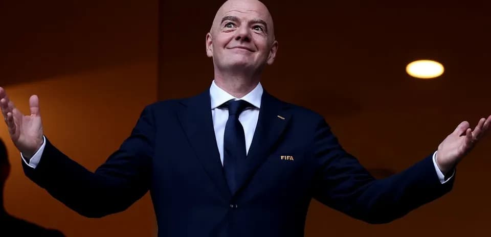 FIFA president gesturing from VIP box