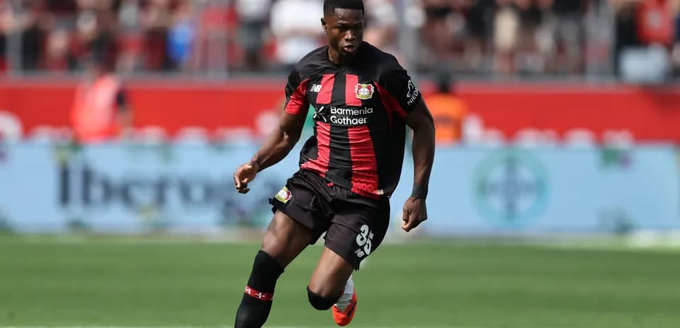 Player in Bayer Leverkusen kit dribbling ball
