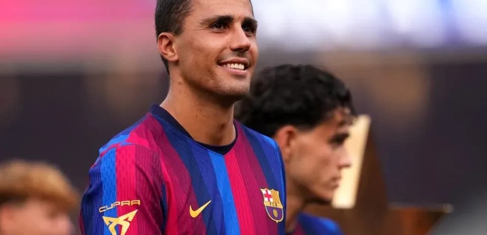 Player smiling while celebrating with teammates