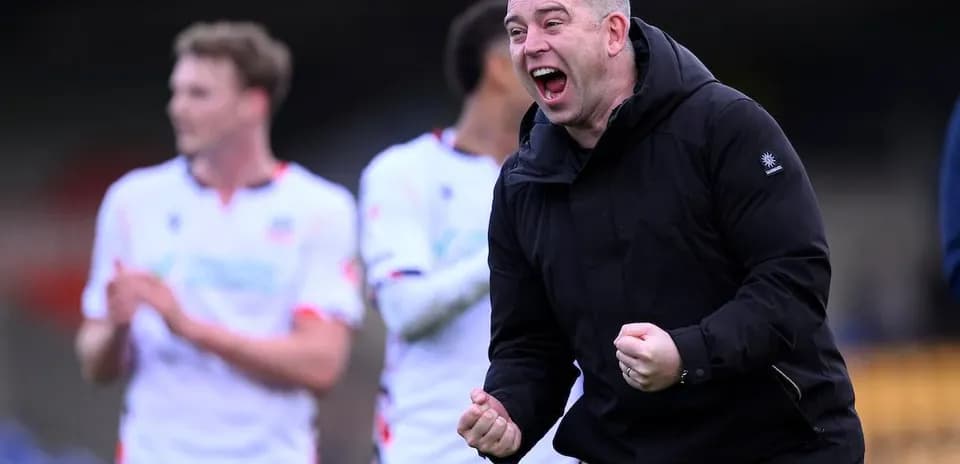 Coach celebrating with team after match victory