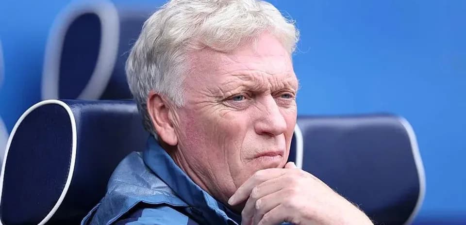 Coach sitting thoughtfully on the bench