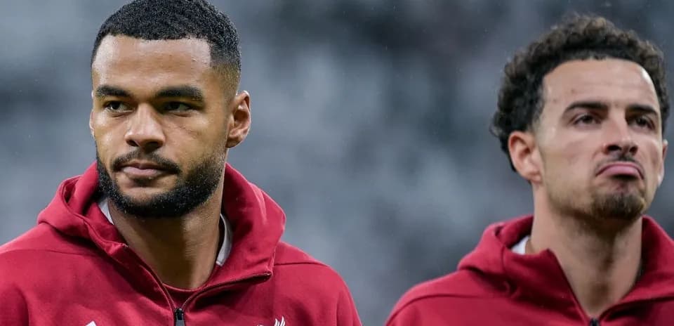 Liverpool players preparing for match on pitch