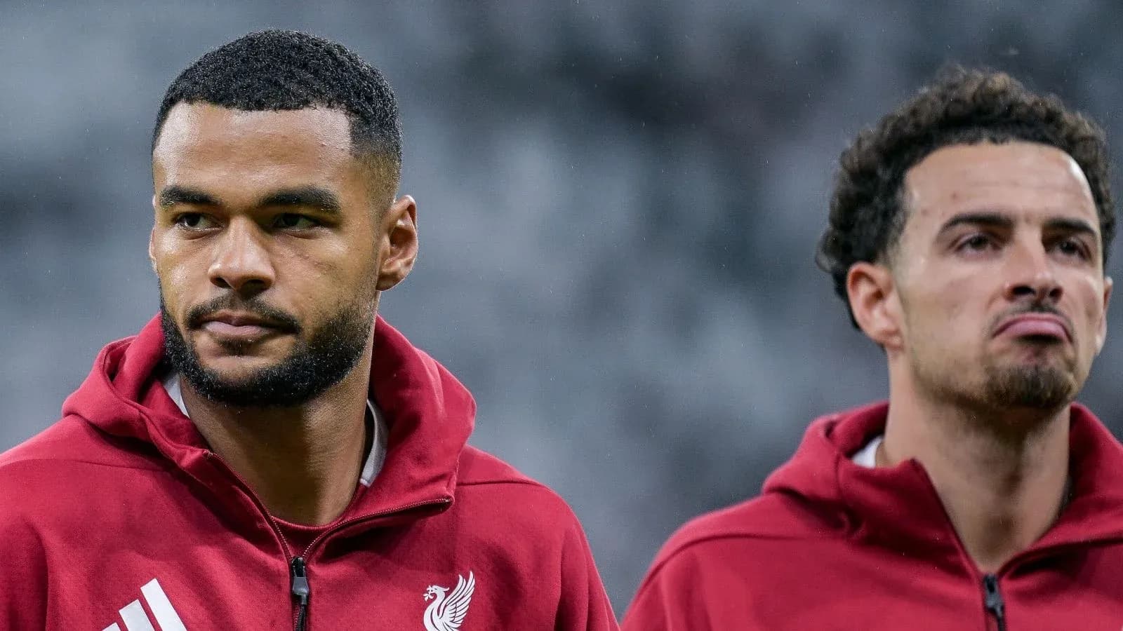 Liverpool players preparing for match on pitch