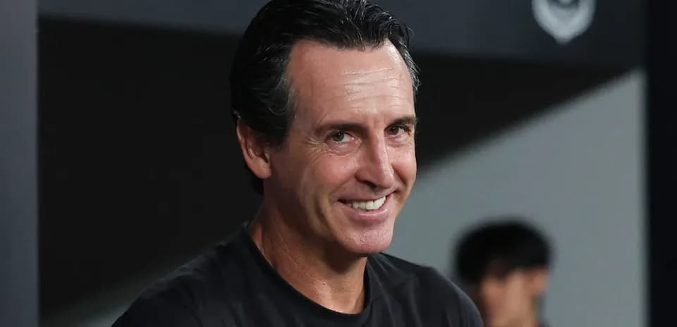 Football manager smiling during a match