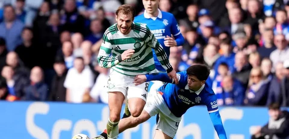 Celtic player evading a tackle from Rangers player