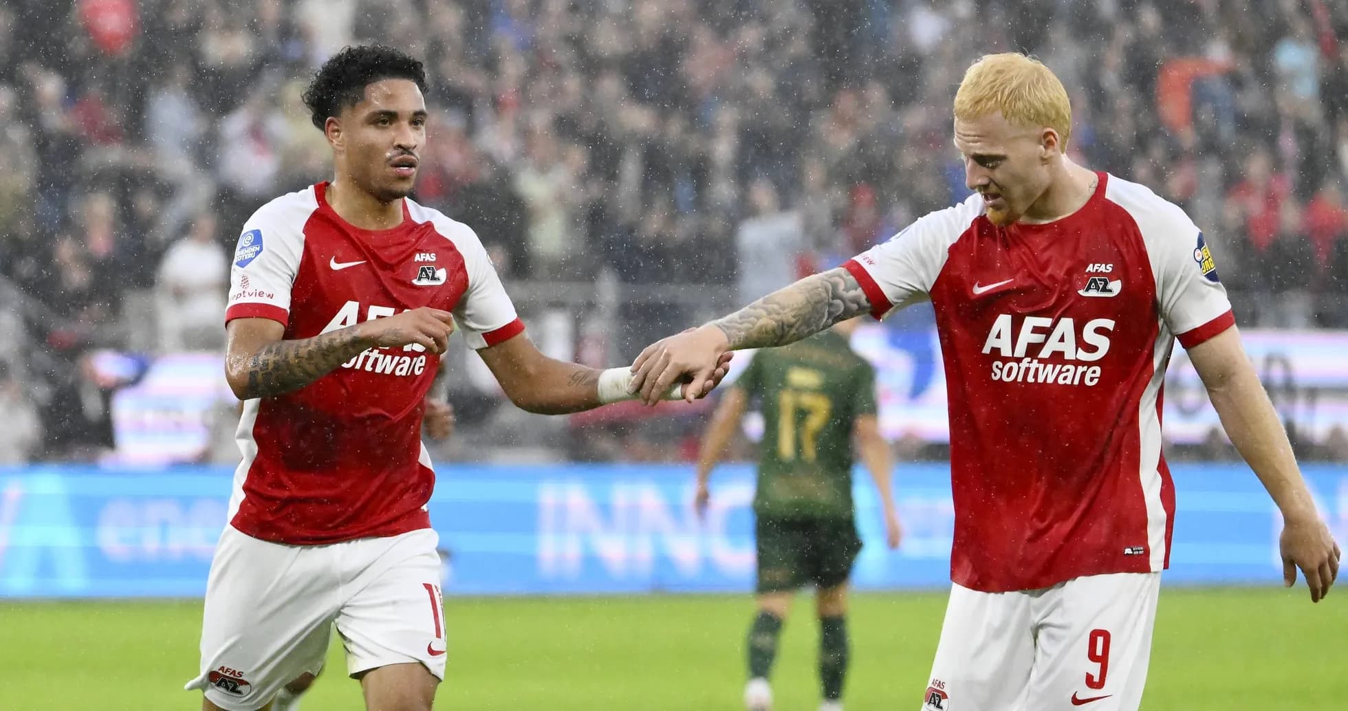 Two AZ Alkmaar players celebrating during a match