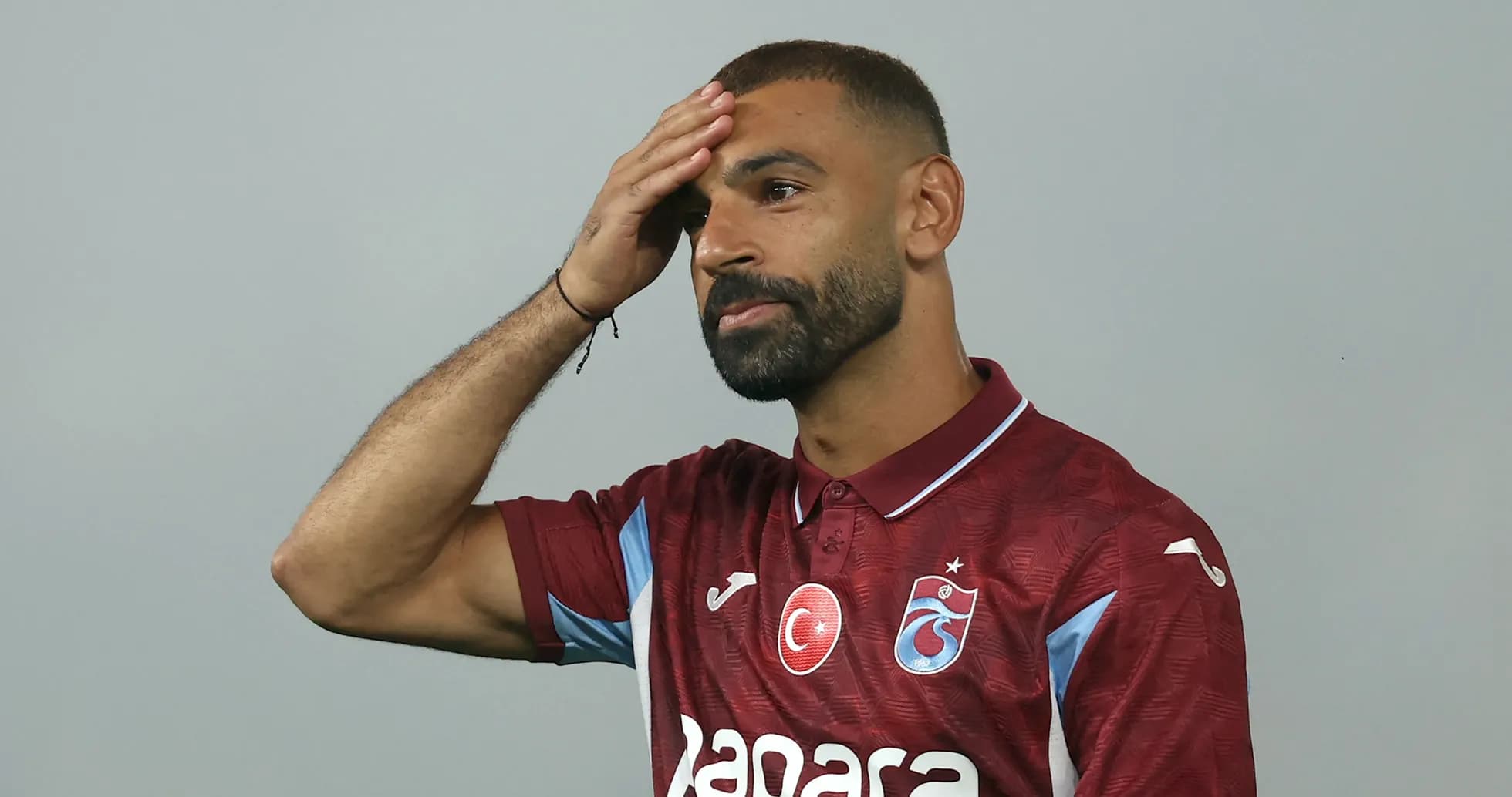 Player wearing maroon jersey with team logo
