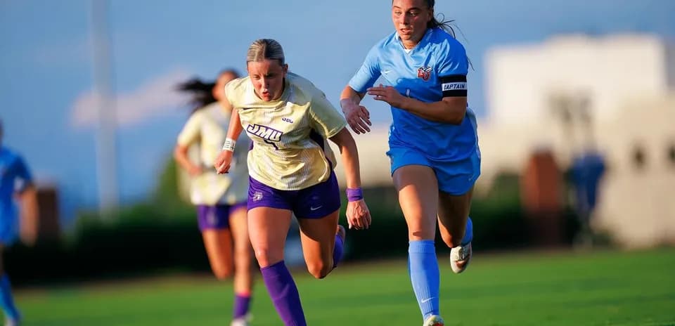 Two soccer players sprinting on the field