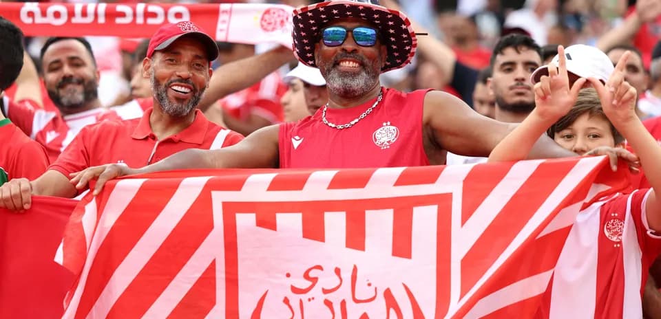 Fans celebrating with a club flag in stadium