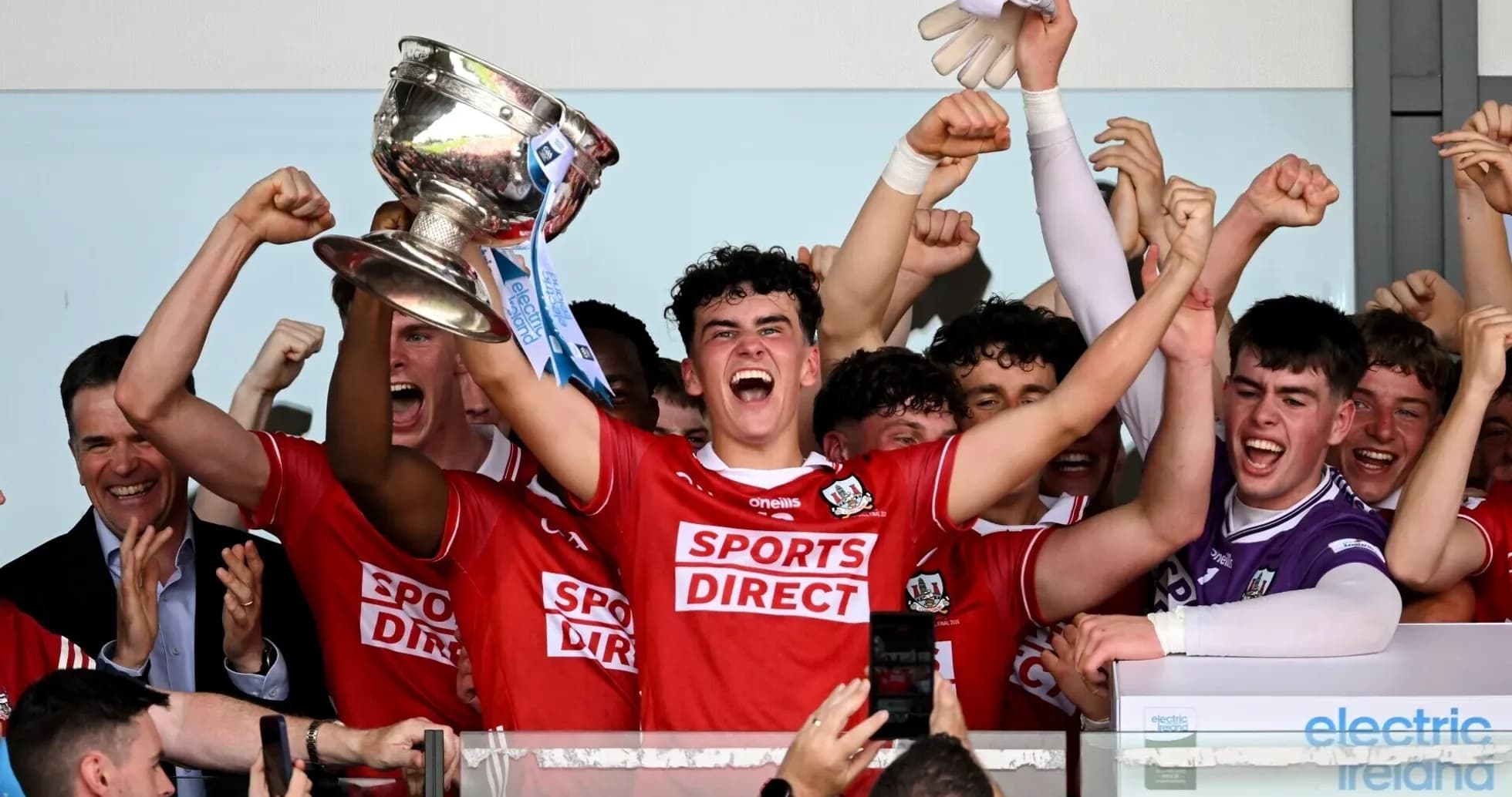 Team celebrating with trophy after victory