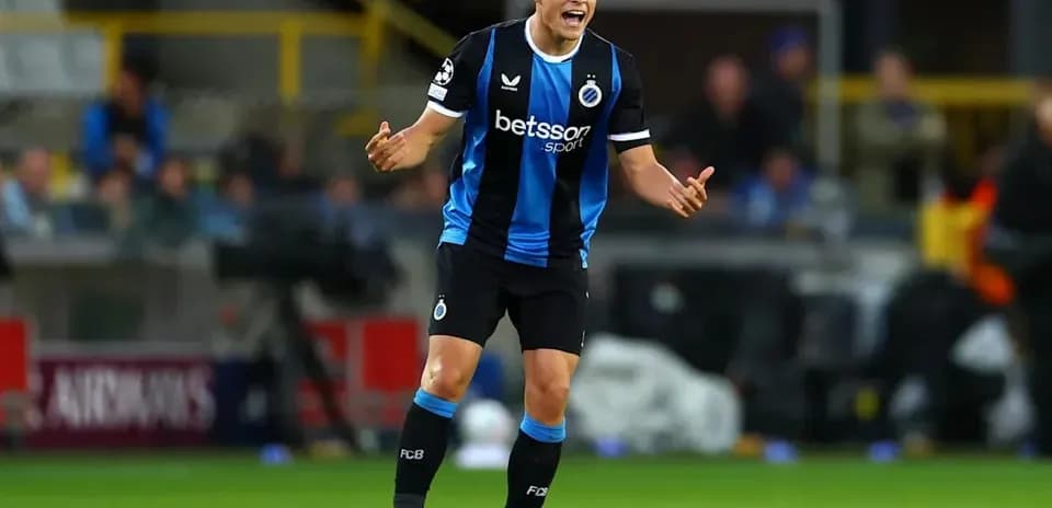 Player gesturing during a match in blue and black kit
