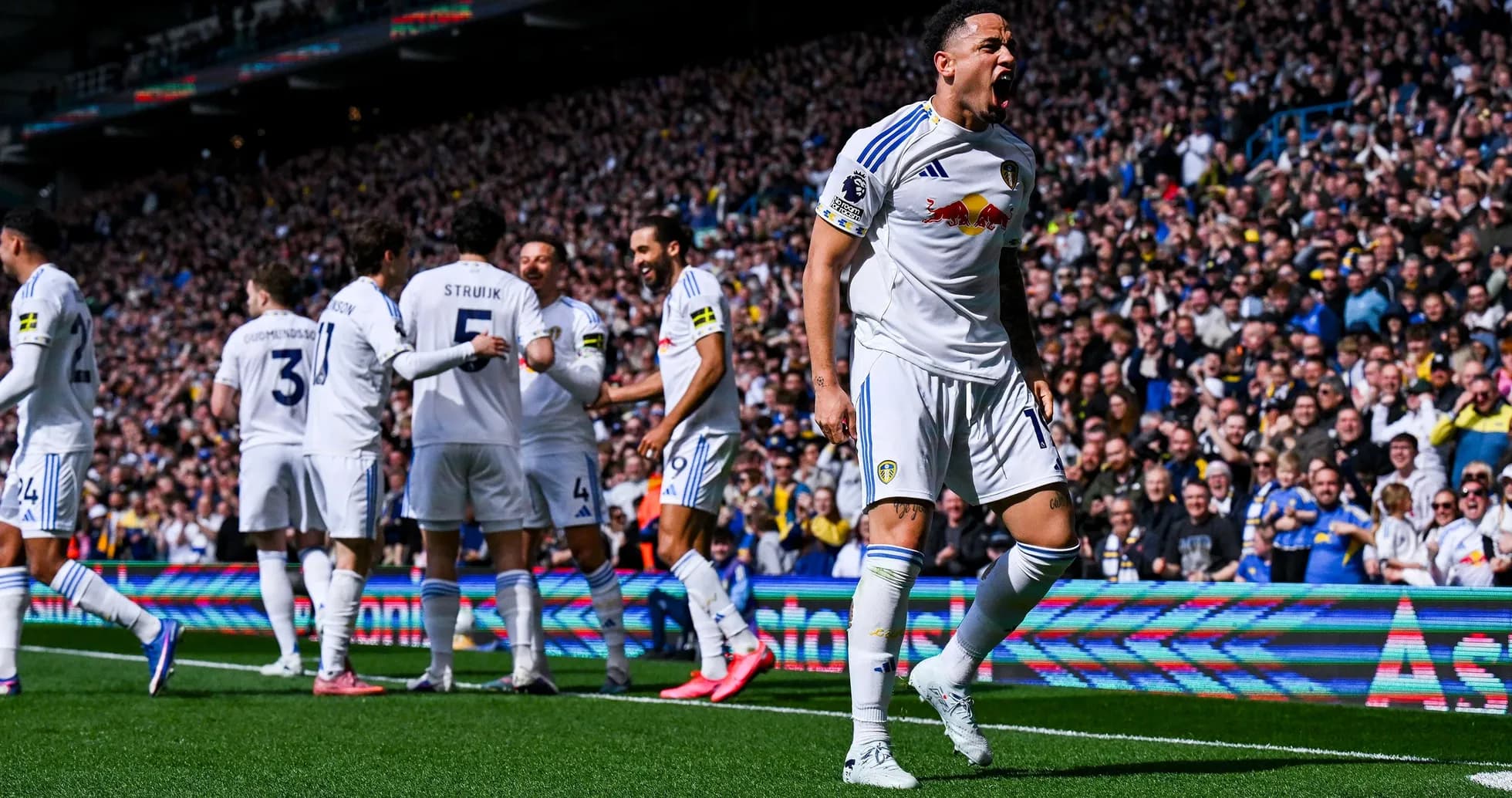 Leeds player celebrating a goal at home stadium
