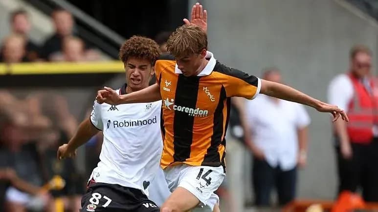 Two players contesting for the ball during match