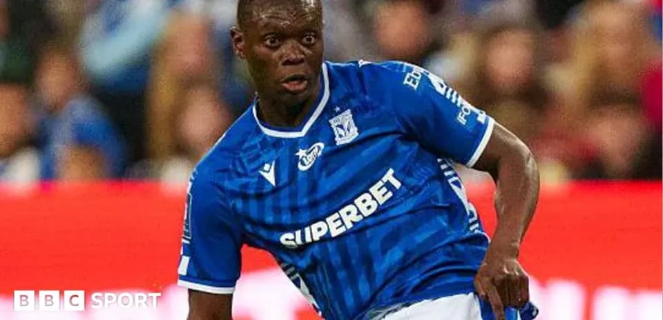 Player in blue jersey dribbling the ball on field