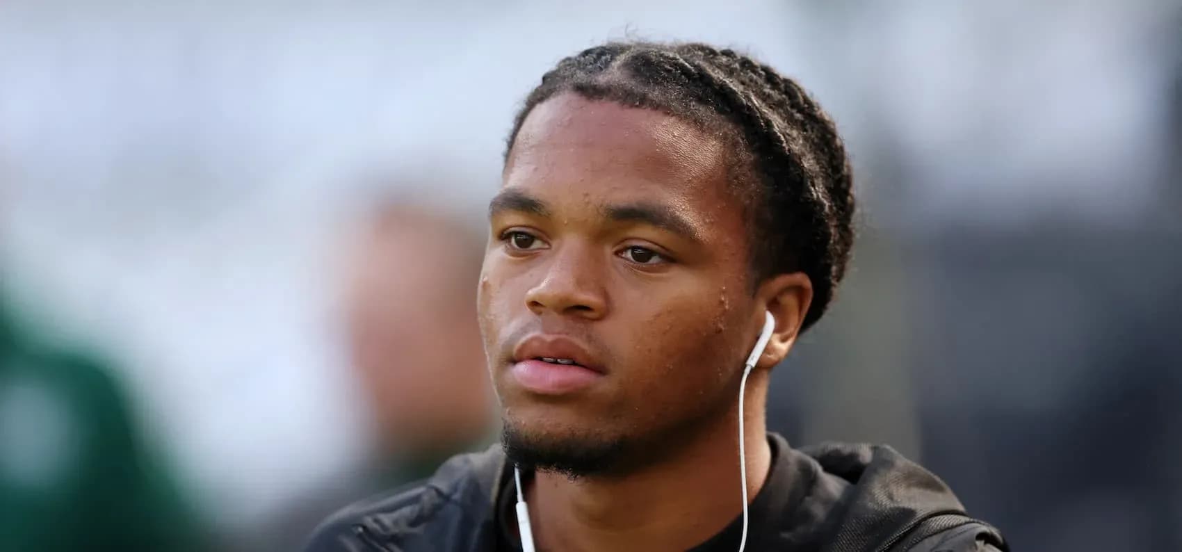 Player wearing earbuds, focused before the match