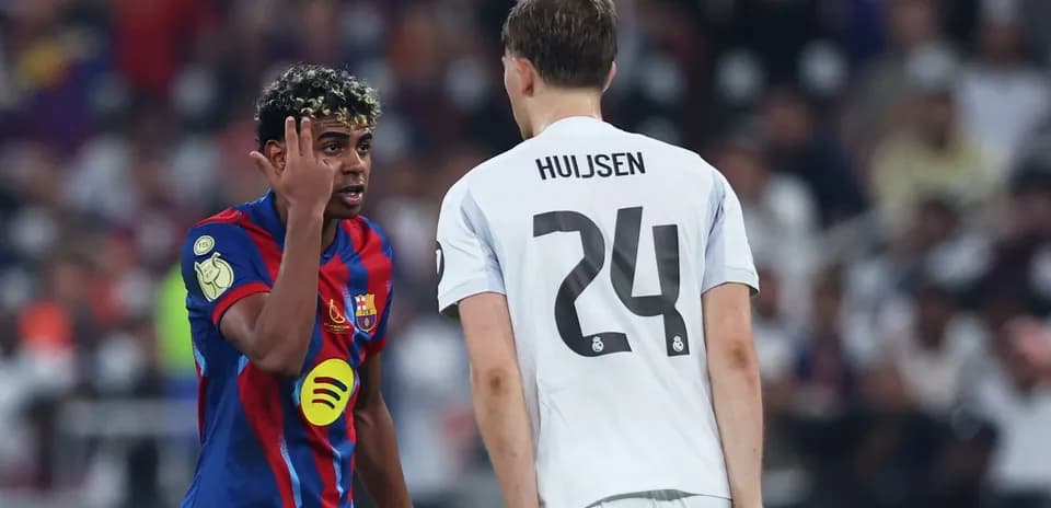 Barcelona player interacting with Real Madrid opponent