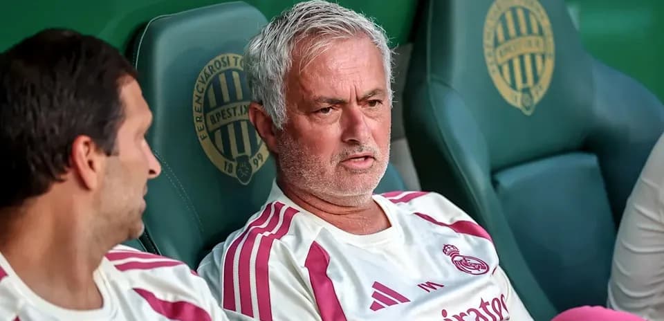 Coach and player sitting on team bench