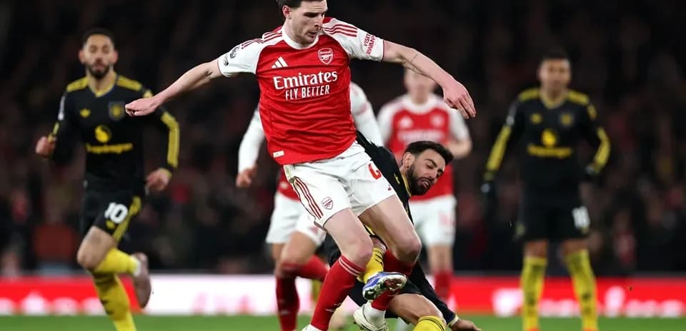 Player tackling opponent during Arsenal match