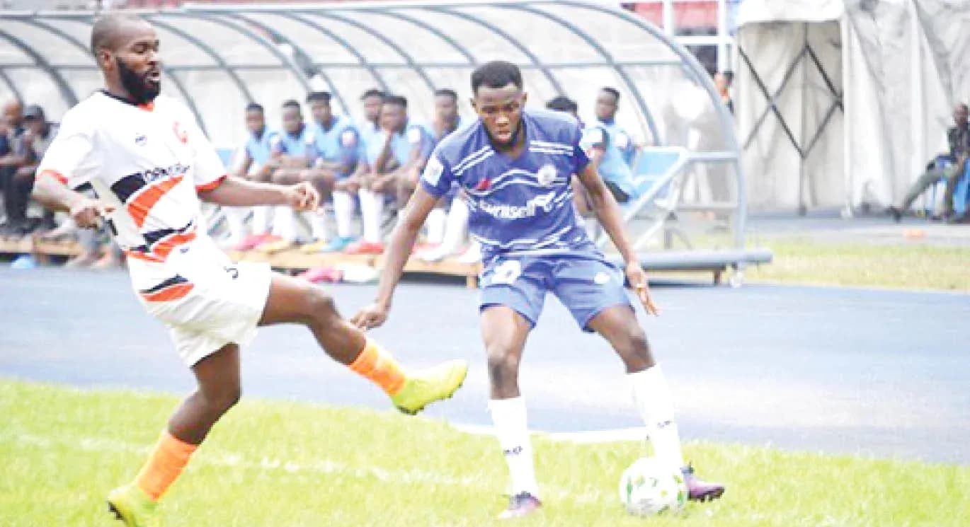 Rivers United player dribbling against Plateau United