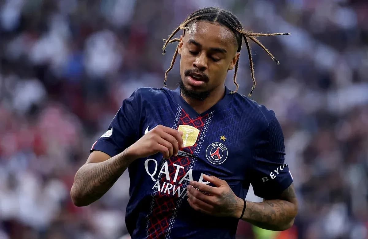 Player examining medal on Paris Saint-Germain jersey