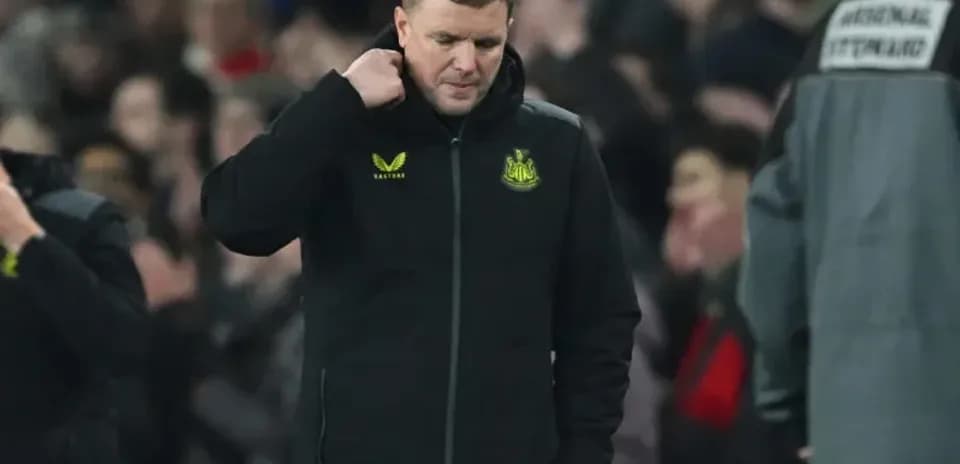Newcastle United manager walking off pitch after match