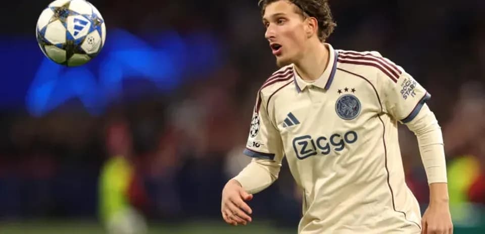 Player in Ajax kit controlling a soccer ball