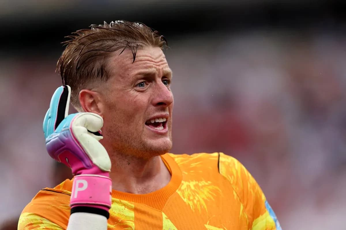 Goalkeeper gesturing during match with colorful gloves