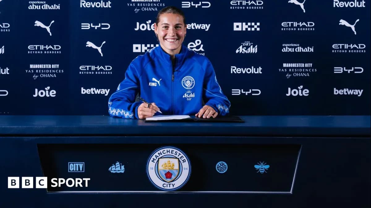 Player signing contract at Manchester City press conference