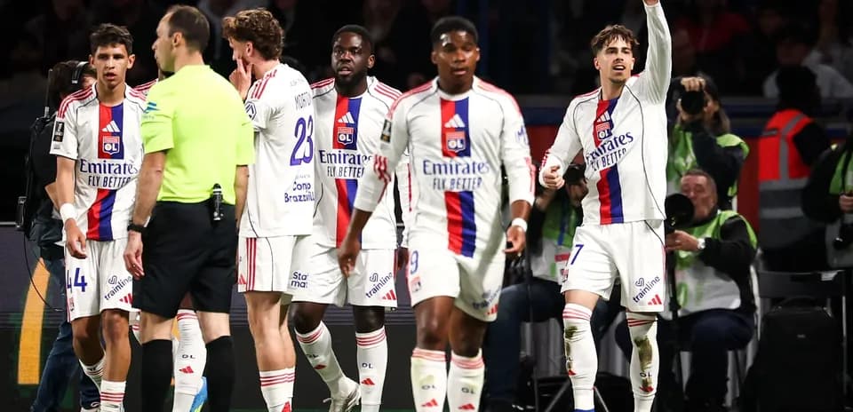 Lyon players interacting with referee during match