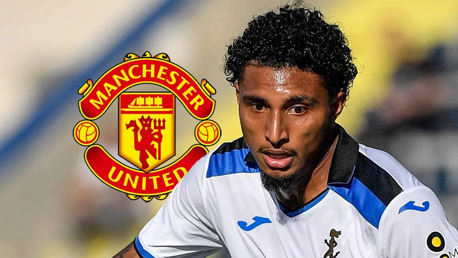 Player in action with Manchester United logo in background