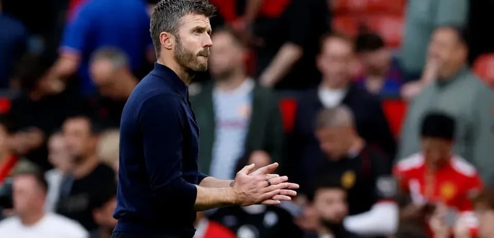 Coach applauding during a match at Old Trafford