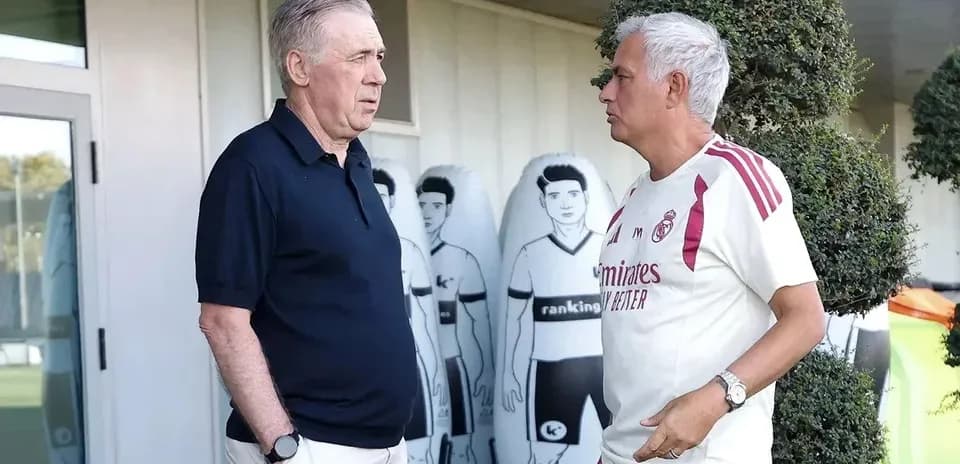 Two coaches talking at a training facility