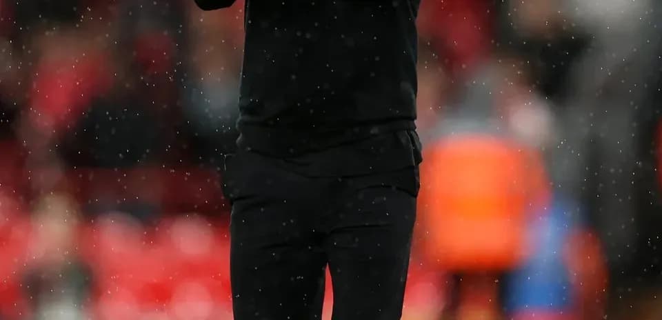 Coach clapping on the sidelines during match