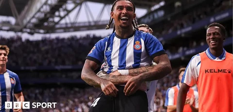 Player celebrating a goal with teammates on field