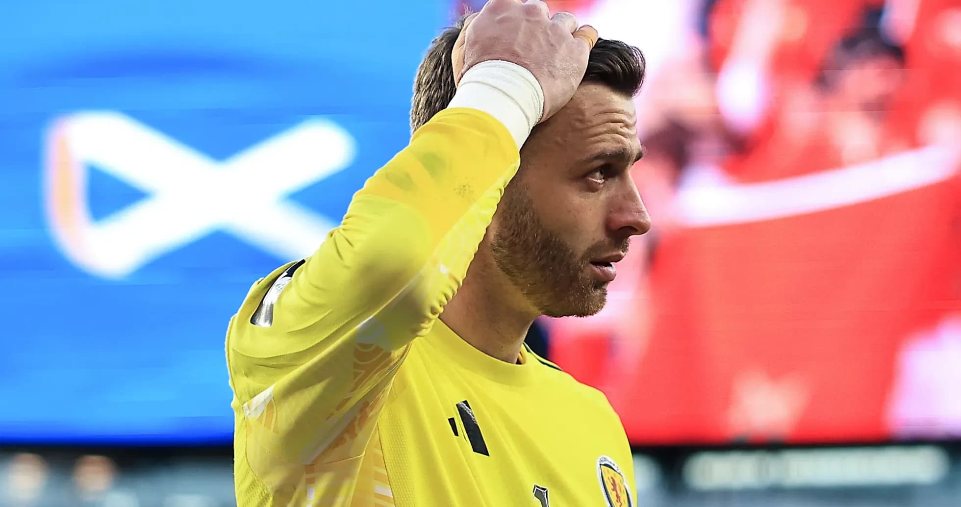 Goalkeeper in yellow kit reacting during match