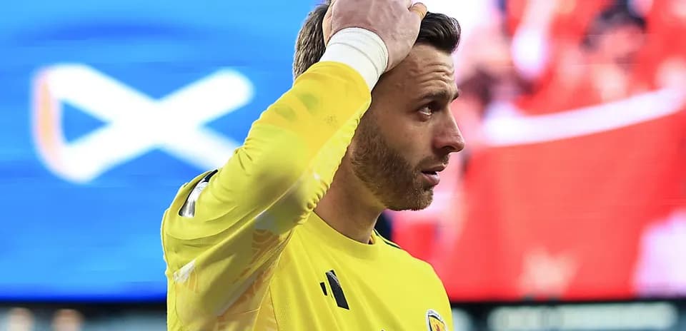 Goalkeeper in yellow kit reacting during match