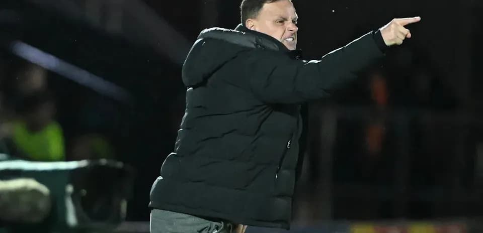 Coach directing players from the sideline during match