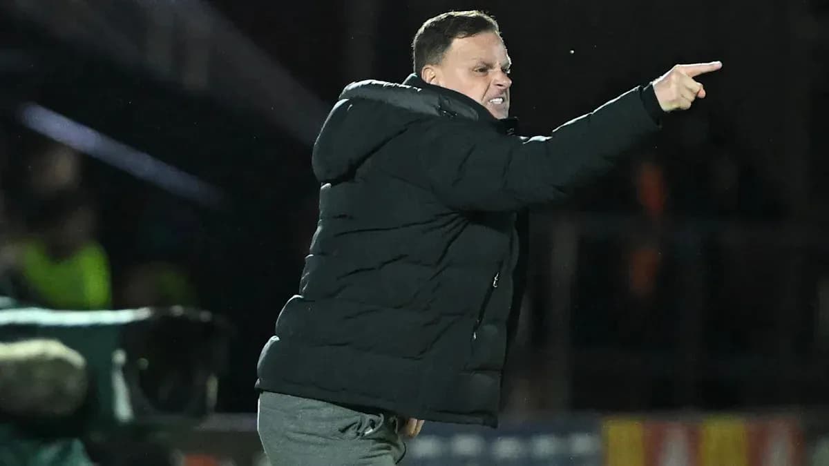 Coach directing players from the sideline during match