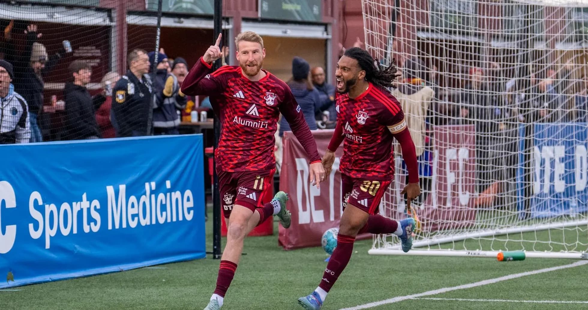 Players celebrating a goal during Detroit City match