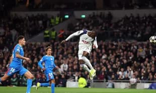 Player heading the ball during Champions League match
