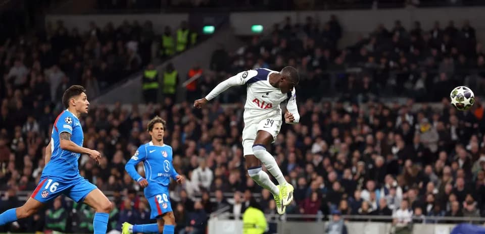 Player heading the ball during Champions League match